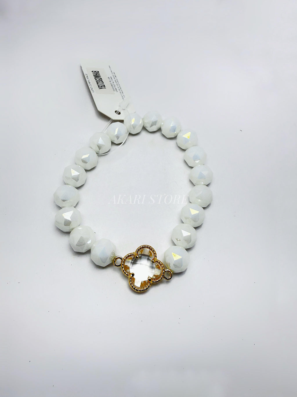 Pulsera con trébol dorado con cuencas blancas facetadas