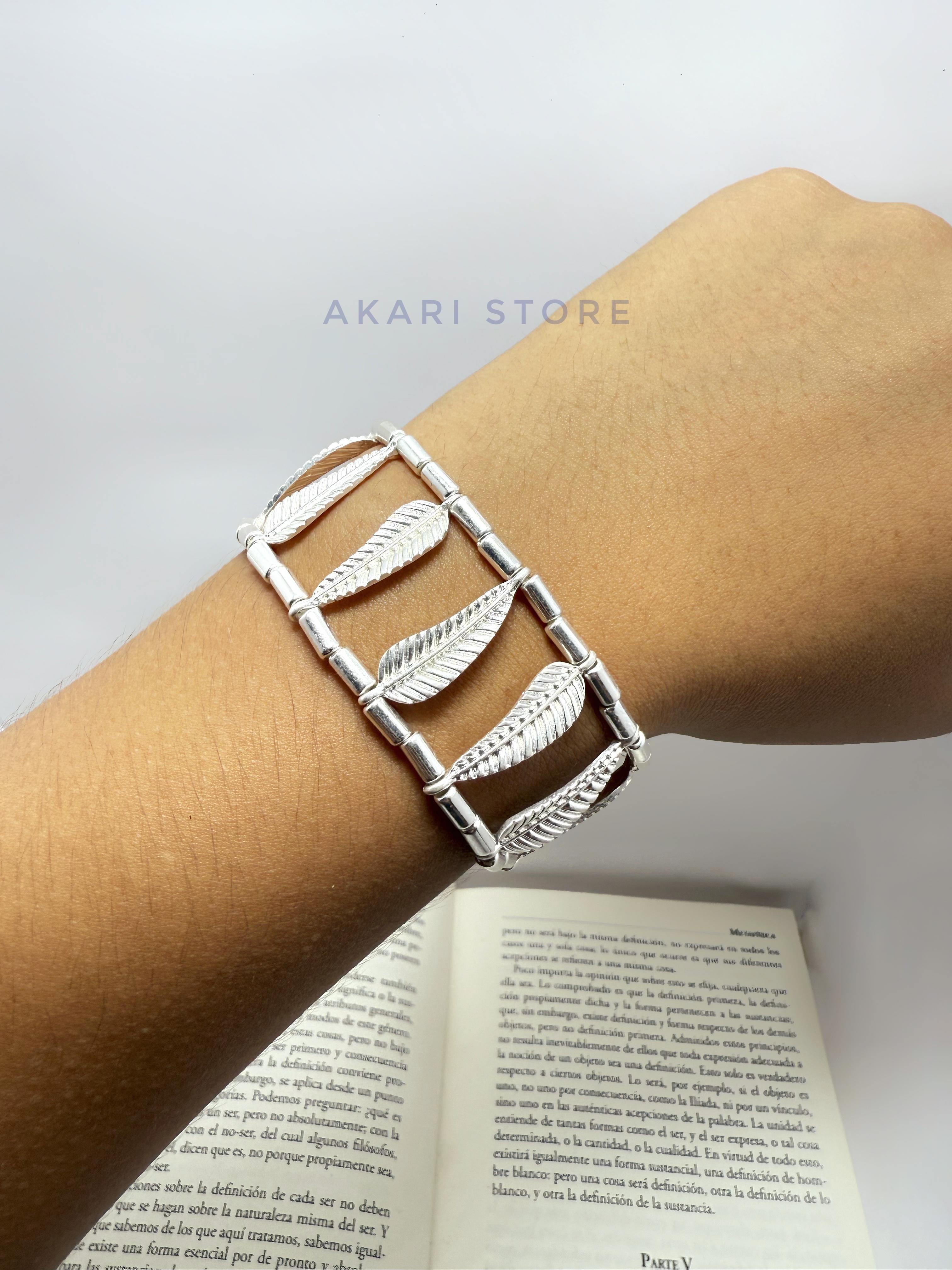 Brazalete con pluma y cuencas metálicas